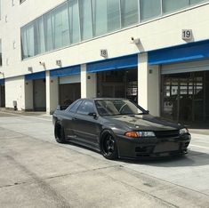 a black car parked in front of a building