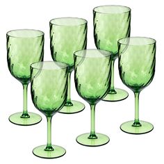 six green wine glasses sitting next to each other