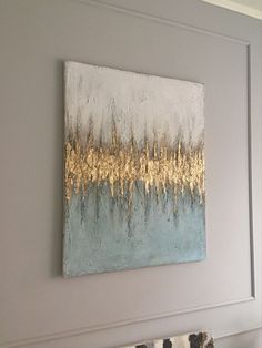 a painting hanging on the wall above a couch