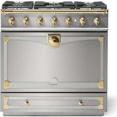 a silver stove with gold trim and knobs