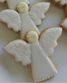 decorated cookies with angel wings and white frosting