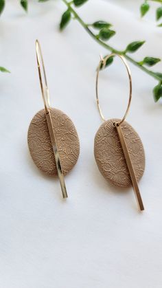 the gold hoop earrings are made out of wood and has a thin bar on each side