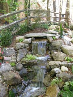 a small waterfall in the middle of a garden