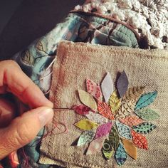 someone is stitching something on the side of a piece of fabric that has been sewn together