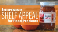 two tomatoes sitting on top of a counter next to a jar of shell appeal for food products