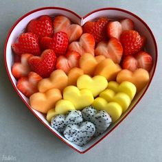 a heart shaped box filled with different types of fruit