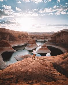 a person standing on top of a large rock