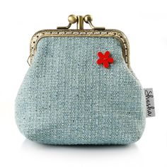 a blue purse with a red flower on it