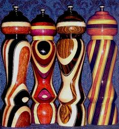 an assortment of colorful vases sitting on top of a table