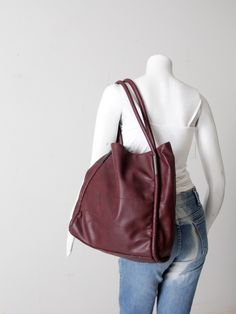 "This is a vintage Neiman Marcus leather tote bag.  The large soft body tote features rolled leather piping trim with metal accents at the tops of the handles.  Tone on tone topstitching stripes the bag.  Interior is lined.  CONDITION In good condition with wear consistent with age and use.  MEASUREMENTS Width:  13\"  ..  33 cm Height:  14\"  ..  35.6 cm Depth: 5.5\"  ..  14 cm Strap Drop:  10\"  ..  25.4  cm 72228" Burgundy Hobo Bag With Large Capacity For Travel, Burgundy Hobo Bag For Travel With Large Capacity, Burgundy Large Capacity Hobo Bag For Travel, Burgundy Soft Leather Tote Shoulder Bag, Burgundy Bag With Double Leather Handles, Burgundy Satchel With Leather Handles For Errands, Burgundy Bags With Leather Double Handles, Burgundy Double Handle Bag With Leather Handles, Burgundy Tote Bag