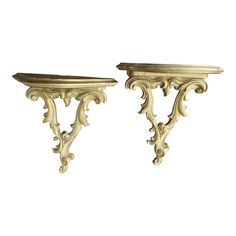 pair of antique gold painted wood shelf brackets on white background with clipping for text