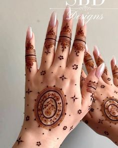 two hands with hendi designs on them