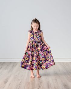 "Our beautiful plum purple floral sun dress is shown in a midi or tea length, also available in a maxi length.  The fully lined bodice features a raised waist, flutter sleeves and elastic neckline make for easy dressing. Above elbow or 3/4 sleeve option also available.  The full skirt makes for fun twirling at birthday parties, family events, wedding receptions, church functions or more! Matching doll dresses can be added to your dress purchase by using the following listing:  https://www.etsy.c Girls Midi, Floral Sun Dress, Purple Plum, Easy Dressing, Doll Dresses, Wedding Receptions, Dress Costume, Family Events, Dress Purple