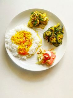 a white plate topped with rice and veggies