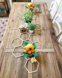 the table is made out of wood and has flowers on it, along with potted plants