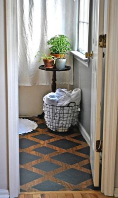 a door way with a basket and potted plant on the floor next to it