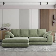 a living room with a green couch and white walls