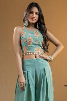 Teal halter neck top with floral prints and shell edging embroidery. Paired with flared palazzo.
Components: 2
Pattern: Printed
Type Of Work: Floral
Neckline: Halter neck
Sleeve Type: Sleeveless
Fabric: Cotton georgette
Color: Blue, Green
Other Details: 
Shell detailing
Attached lining
Occasion: Puja - Aza Fashions Edging Embroidery, Flared Palazzo, Palazzo Set, Halter Neck Top, Fashion App, Set For Women, Aza Fashion, Fashion Set, Halter Neck