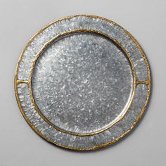 two silver and gold plates sitting on top of each other