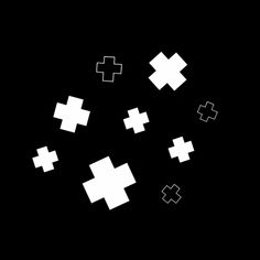 white crosses are flying through the air on a black background