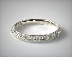 a white gold wedding band with rows of diamonds