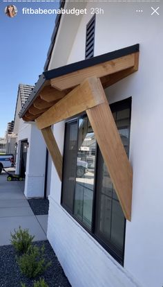 a white building with a wooden roof and windows