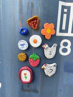 some colorful magnets on the side of a blue door