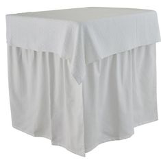 a white bed skirt with ruffled edges