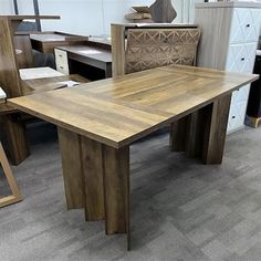 a wooden table sitting on top of a carpeted floor