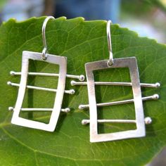 My ladder earrings are entirely hand fabricated and formed from sterling silver, and hang on hand bent silver ear wires.  They're whimsical,unique, modern, and chic.  These are all made to order and OOAK, the pair you receive my vary slightly from the image.please note-the earrings I'm wearing to showcase size-are my personal pair. Modern Sterling Silver Linear Earrings With Ear Wire, Unique Sterling Silver Wrap Earrings, Unique Sterling Silver Pierced Wrap Earrings, Modern Handmade Wrap Earrings, Modern Wire Wrapped Sterling Silver Earrings, Modern Handmade Wrap Earrings For Everyday, Modern Sterling Silver Wrap Earrings, Modern Sterling Silver Drop Wrap Earrings, Unique Nickel-free Sterling Silver Wrap Earrings