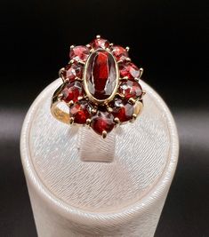 Beautiful antique garnet ring in a Bohemian design... The ring is in 585/000 14K. Made of yellow gold and has a large red garnet stone in the middle - around it are 10 small stones incorporated in a prong setting. Beautiful antique garnet made in German blacksmith work in the original Bohemian design. Details: Gold: 585/000 14K yellow gold Stone: Garnet 1 large 10 small Size: 17 Weight: 5 grams Visit our shop for more beautiful pieces of jewelry: Shop by FJValoren on Etsy https://www.etsy.com/de Antique Garnet Ring, Ring Antique, Garnet Ring, Garnet Stone, Bohemian Design, Gold Stone, Garnet Rings, Red Garnet, Antique Rings