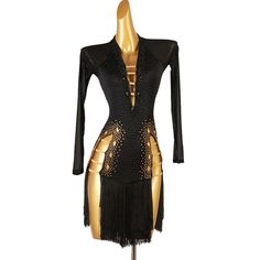 a black and gold dress on a mannequin's torso with fringes