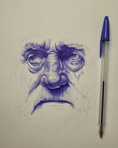 a drawing of an old man's face with a beard and mustache, next to a pen