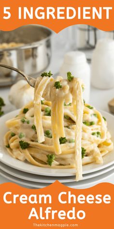 a plate with pasta and broccoli being held up by a fork over it