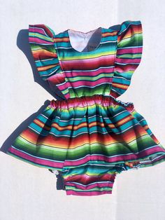 Perfect for all the summer 🥳 FIESTAS!! Handmade skirt romper. Made with cotton serape cotton fabric. These amazing pieces are made to order. Sizes 0-6 month up to 4T are made with attached bloomers and snaps at the saddle. Anything above a 4t (5t -7/8y) are the same style dress with no bloomers attached. If you have any questions on sizing please don't hesitate to message me. I will gladly help. Multicolor Short Sleeve Twirl Dress With Ruffles, Multicolor Twirl Dress With Ruffles And Short Sleeves, Spring Rainbow Print Short Sleeve Dress, Spring Dresses With Rainbow Print And Short Sleeves, Fitted Cotton Twirl Dress For Party, Multicolor Short Sleeve Twirl Dress For Summer, Playful Rainbow Dress With Ruffles, Multicolor Ruffle Twirl Dress For Playtime, Multicolor Ruffled Twirl Dress For Playtime