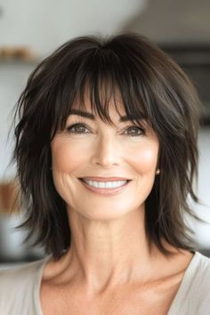 Save this pin for the best shag hairstyles for women over 50. This mid-length, shaggy style strikes the perfect balance of length and texture. The layers move beautifully without being too choppy. Medium Shag With Bangs Over 50, Short Shaggy Haircuts Choppy Layers Fine Hair Bob Hairstyles, Medium Length Choppy Layers, Layered Bob Hairstyles Shoulder Length, Mid Length Haircut With Bangs, Medium Shag Hairstyles, Haircut Gray Hair, Long Shag Hairstyles, Medium Shag