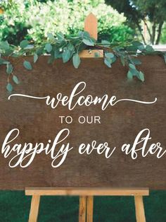 a sign that says welcome to our happily ever after with greenery on it and the words,'welcome to our happily ever after '