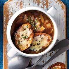 a white bowl filled with soup and some bread