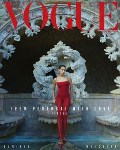 a woman standing in front of a fountain on the cover of a magazine