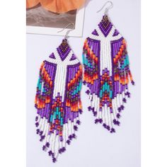 Beaded Tassel Drop Earrings Color: Purple & White Measurements: 5.5 Inches In Length 1.25 Inches In Width Purple Beaded Fringe Earrings For Festivals, White Beaded Fringe Earrings For Festival, White Colorful Beads Drop Tassel Earrings, White Colorful Beads Tassel Drop Earrings, White Tassel Drop Earrings With Colorful Beads, White Dangle Tassel Earrings For Festivals, White Fringe Tassel Earrings For Festivals, Bohemian Purple Beaded Earrings For Beach, Traditional White Beaded Tassel Earrings