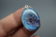 "If you are searching for a truly unique and breathtaking memorial gift, look no further than our milky way pendants! These cremation galaxy necklaces are handcrafted for you with the ashes you provide. Each swirling, shimmery galaxy is set in a 18x25mm oval sterling silver pendant and hangs from your choice of sterling silver chain. These galactic necklaces are built in layers to give them as much depth as possible. In the comments box, please note how defined you would like the \"swirl\" to be Celestial Resin Jewelry As A Gift, Celestial Resin Jewelry As Gift, Celestial Resin Jewelry For Gifts, Celestial Style Resin Jewelry For Gifts, Handmade Memorial Necklace With Oval Pendant, Handmade Celestial Resin Jewelry, Handmade Resin Jewelry For Weddings, Unique Handmade Memorial Jewelry, Unique Handmade Jewelry For Memorial