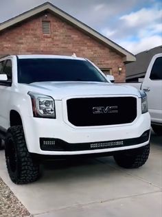 a white truck parked in front of a house