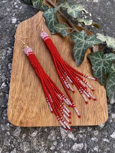 Long red beaded fringe earrings, seed bead earrings dangle boho earrings native beaded earrings chandelier earrings colorful earrings ♥𝑇ℎ𝑒 𝑝𝑎𝑡𝑡𝑒𝑟𝑛 𝑜𝑓 𝑡ℎ𝑖𝑠 𝑒𝑎𝑟𝑟𝑖𝑛𝑔 𝑖𝑠 𝑐𝑟𝑒𝑎𝑡𝑒𝑑 𝑏𝑦 𝐾𝑎𝑍𝑒𝐵𝑒𝑎𝑑𝐽𝑒𝑤𝑒𝑙𝑟𝑦 ♥𝑀𝑎𝑑𝑒 𝑢𝑠𝑖𝑛𝑔 𝑓𝑟𝑒𝑒ℎ𝑎𝑛𝑑 𝑏𝑒𝑎𝑑𝑖𝑛𝑔 𝑤𝑜𝑣𝑒𝑛 𝑡𝑒𝑐ℎ𝑛𝑖𝑞𝑢𝑒𝑠 𝑤𝑖𝑡ℎ 𝑠𝑡𝑟𝑜𝑛𝑔 𝑠𝑦𝑛𝑡ℎ𝑒𝑡𝑖𝑐 𝑡ℎ𝑟𝑒𝑎𝑑. ♥𝑇ℎ𝑒 𝑠𝑖𝑧𝑒 𝑜𝑓 𝑡ℎ𝑒 𝑠𝑒𝑒𝑑 𝑏𝑒𝑎𝑑𝑠 𝑢𝑠𝑒𝑑 𝑖𝑠 2 𝑚𝑖𝑙𝑙𝑖𝑚𝑒𝑡𝑒𝑟𝑠 𝑎𝑛𝑑 𝑏𝑒𝑎𝑑𝑠 𝑎𝑟𝑒 ℎ𝑖𝑔ℎ 𝑞𝑢𝑎𝑙𝑖𝑓𝑖𝑒𝑑. ♥𝐴𝑙𝑙 𝑡ℎ𝑒 ℎ𝑜𝑜𝑘𝑠 𝑢𝑠𝑒𝑑 𝑖𝑛 𝑜𝑢𝑟 𝑗𝑒𝑤𝑒𝑙𝑟𝑦 𝑎𝑟𝑒 24 𝑘 𝑔𝑜𝑙𝑑 𝑝𝑙𝑎𝑡𝑒𝑑 𝑎𝑛𝑑 ℎ𝑦𝑝𝑜𝑎𝑙𝑙𝑒𝑟𝑔𝑒𝑛𝑖𝑐. ♥𝑇ℎ𝑒𝑠𝑒 𝑎𝑟𝑒 𝑣𝑒𝑟𝑦 𝑙𝑖𝑔ℎ𝑡 𝑒𝑎𝑟𝑟𝑖𝑛𝑔𝑠 𝑡ℎ𝑎𝑡 𝑦𝑜𝑢 𝑐𝑎𝑛 𝑤𝑒𝑎𝑟 𝑎𝑙𝑙 𝑑𝑎𝑦 𝑤𝑖𝑡ℎ𝑜𝑢𝑡 ℎ𝑢𝑟𝑡𝑖𝑛𝑔 𝑦𝑜𝑢𝑟 𝑒𝑎𝑟! The only acc Fringe Earrings With Round Beads As Gift, Red Beaded Tassel Drop Earrings, Red Bohemian Beaded Earrings With Tassels, Red Bohemian Dangle Earrings, Bohemian Red Dangle Earrings, Red Bohemian Chandelier Earrings With Tassels, Bohemian Red Beaded Earrings With Tassels, Traditional Red Beaded Tassel Earrings, Bohemian Red Long Drop Earrings