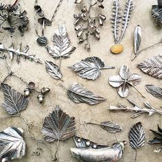 many different metal items are laying on the ground together, including leaves and acorns