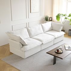 a living room with a white couch and coffee table