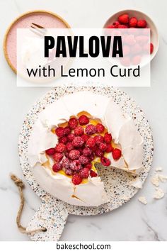 pavlova with lemon curd and raspberries on a white plate next to a bowl of strawberries