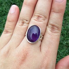 SKU: SS-036Material: 925 stamped sterling silverGemstone(s): Amethyst (N)Gemstone Dimensions: 12 X 17 X 4 mmRing Size: US 7Weight: 6.6 gramsThis remarkable Amethyst cabochon ring features a beautiful royal purple oval Amethyst in a classic bezel setting with an infinity symbol motif at the sides. This Amethyst has a depth and a glow from within that entrances the eye and lures you in. Truly a stunning stone! Twisted Braid, Cabochon Ring, Infinity Symbol, Twist Braids, Royal Purple, Gradient Color, Bezel Setting, Sterling Silver Ring, Silver Ring