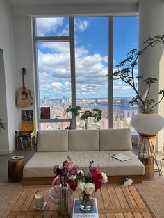 a living room filled with furniture and large windows