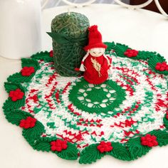 a table topped with a green and red christmas rug next to a bottle of milk