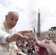 a man is handing something to a person in front of a large group of people